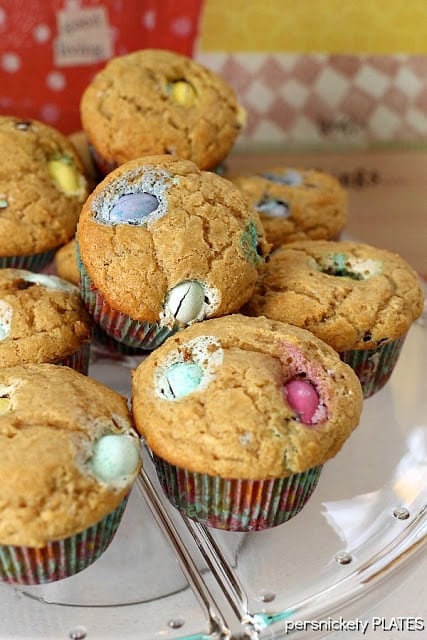 a pile of peanut butter muffins filled with pastel M&Ms. 