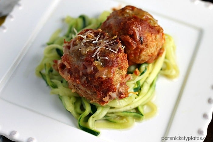 Slow Cooker Cheese Stuffed Turkey Meatballs with Zoodles close up on a white plate.