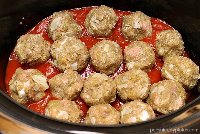 Cheese Stuffed Turkey Meatballs being cooked in a slow cooker.