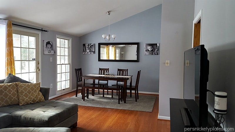 Before and after pictures of our living room/dining room done on a budget. Changing paint makes a huge difference - with Benjamin Moore Stonington Gray & Timber Wolf | Persnickety Plates