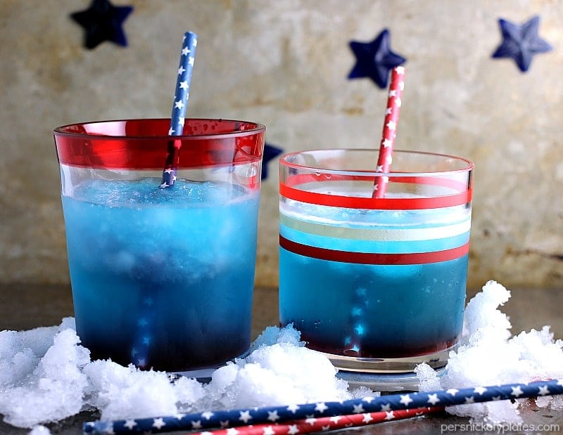 two red white & blue cocktails sitting in crushed ice.