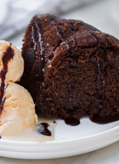 chocolate bundt cake with vanilla ice cream on white plate