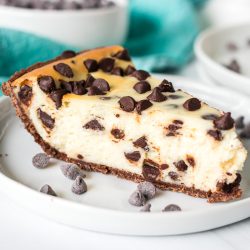 slice of chocolate chip cheesecake on a white plate.