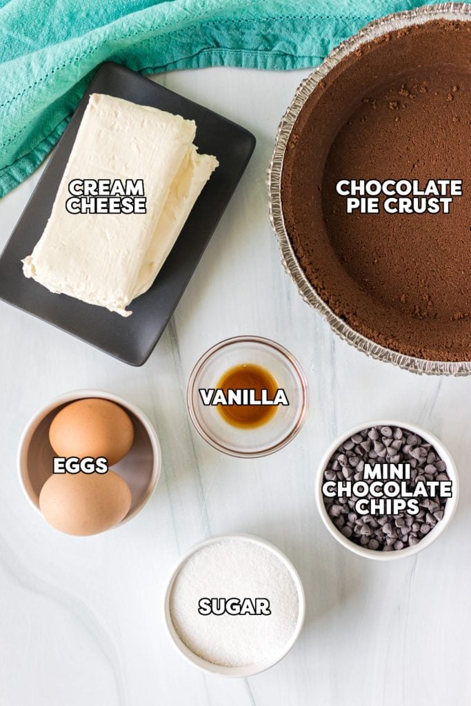 overhead shot of labeled ingredients laid out to make cheesecake.