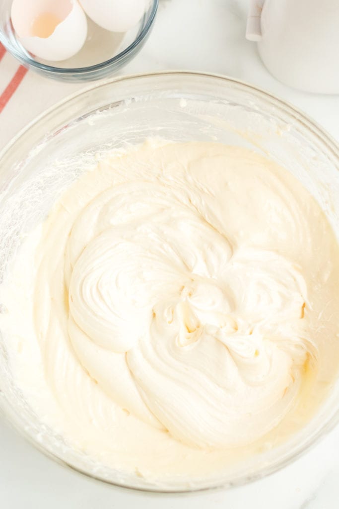 cheesecake batter in a glass mixing bowl.