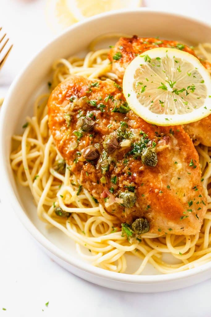 chicken piccata on a bed of noodles.