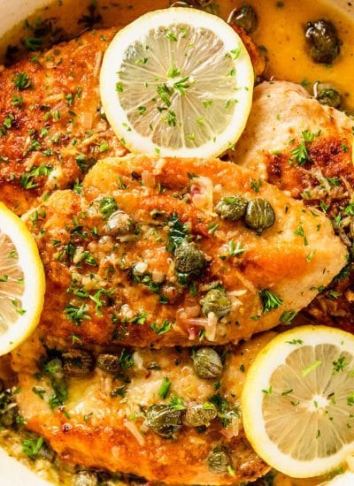 chicken piccata covered in capers and lemon slices.