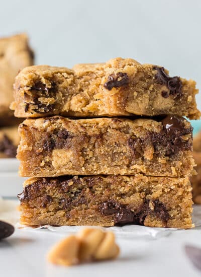 3 chocolate chip peanut butter blondies in a stack.