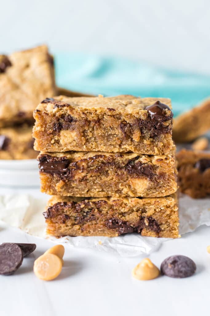 stack of 3 peanut butter blondies with melty chocolate chips.