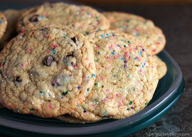 These Perfect Party Cookies start with a cake mix and are full of chocolate chips and sprinkles. Mix up the colors to suit whatever type of party you're having! | Persnickety Plates
