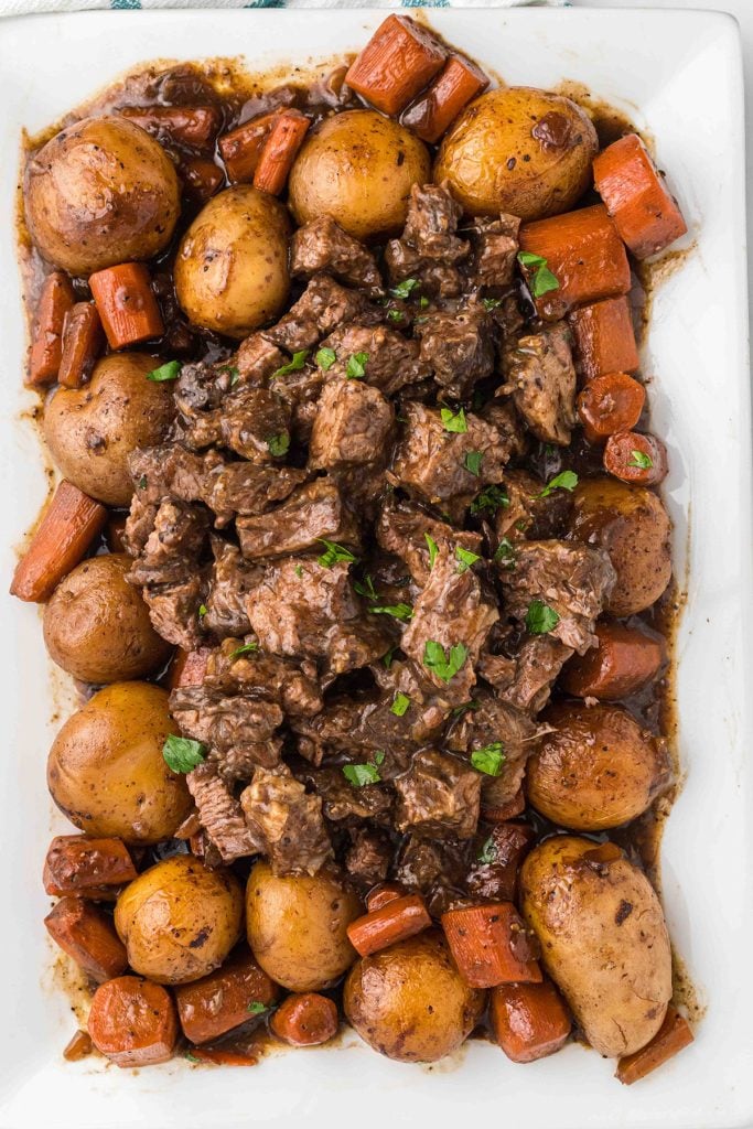 overhead shot of roast beef, potatoes, and carrots on a platter.
