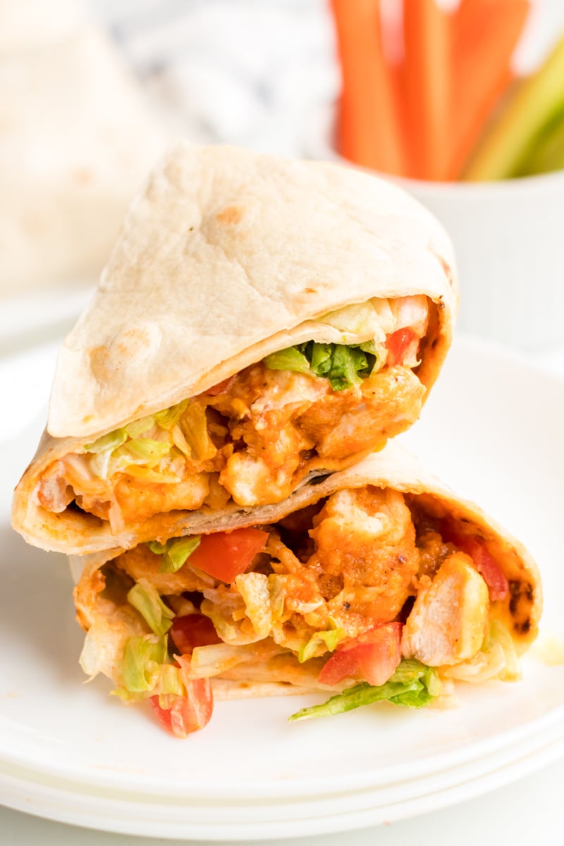 sliced & stacked buffalo ranch chicken wrap on a white plate 