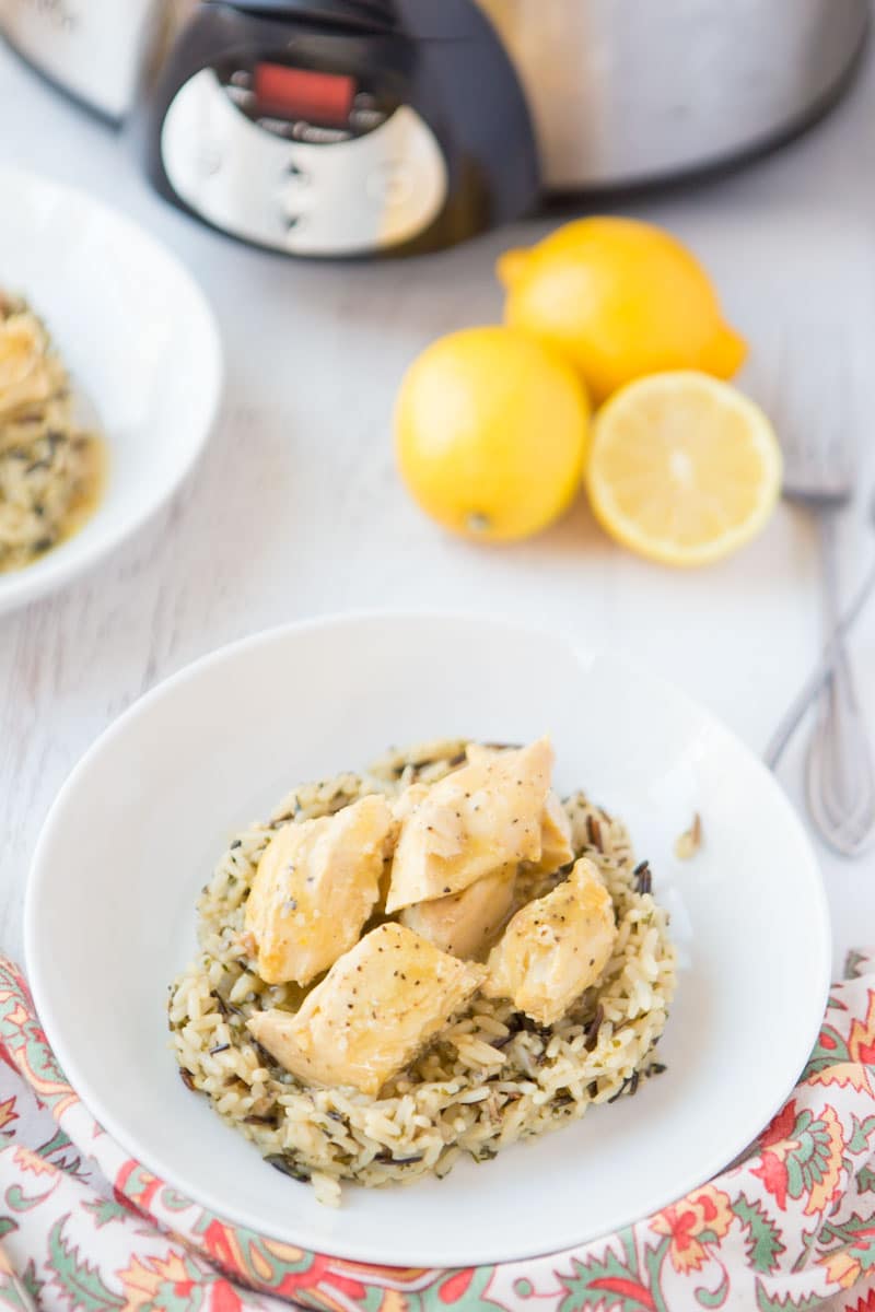 lemon chicken on wild rice with slow cooker & lemons in background