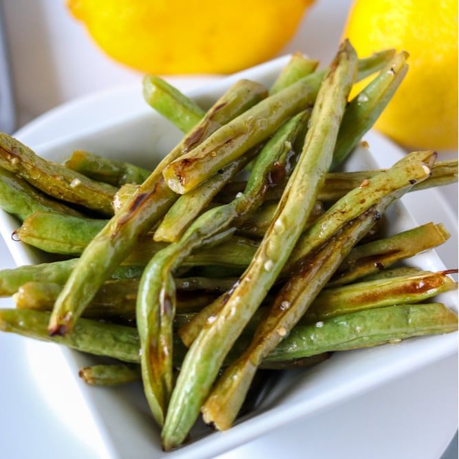 white bowl of oven roasted garlic green beans 