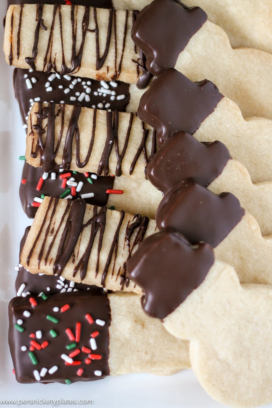 platter of chocolate dipped shortbread cookies in rectangles & snowman shapes