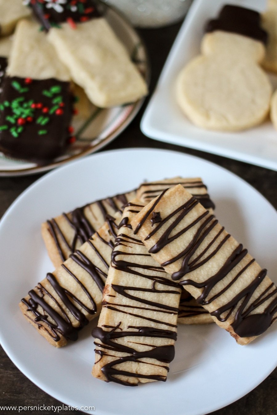white plate of shortbread cookies drizzled with chocolate