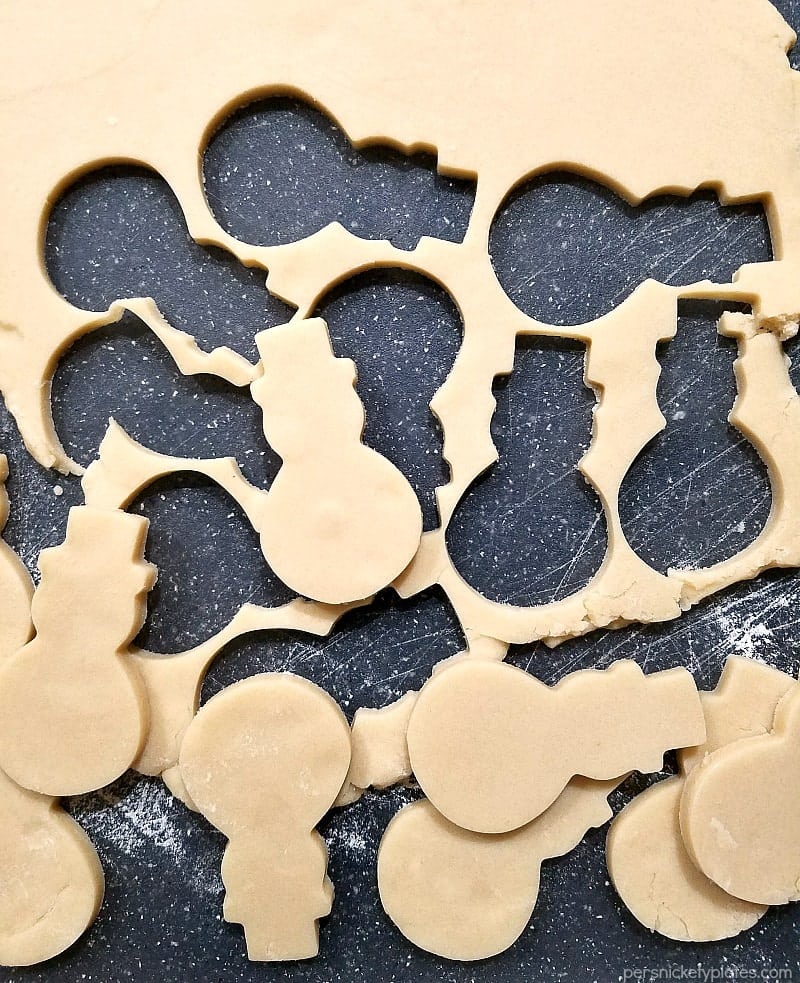 cutting board with snowman cookie cut-out shapes