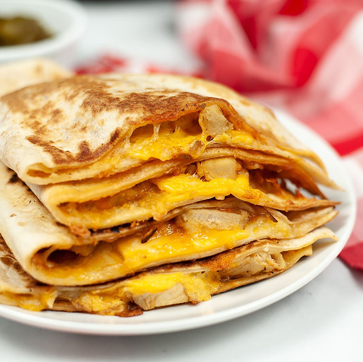 taco bell copycat quesadilla on a white plate with red napkin