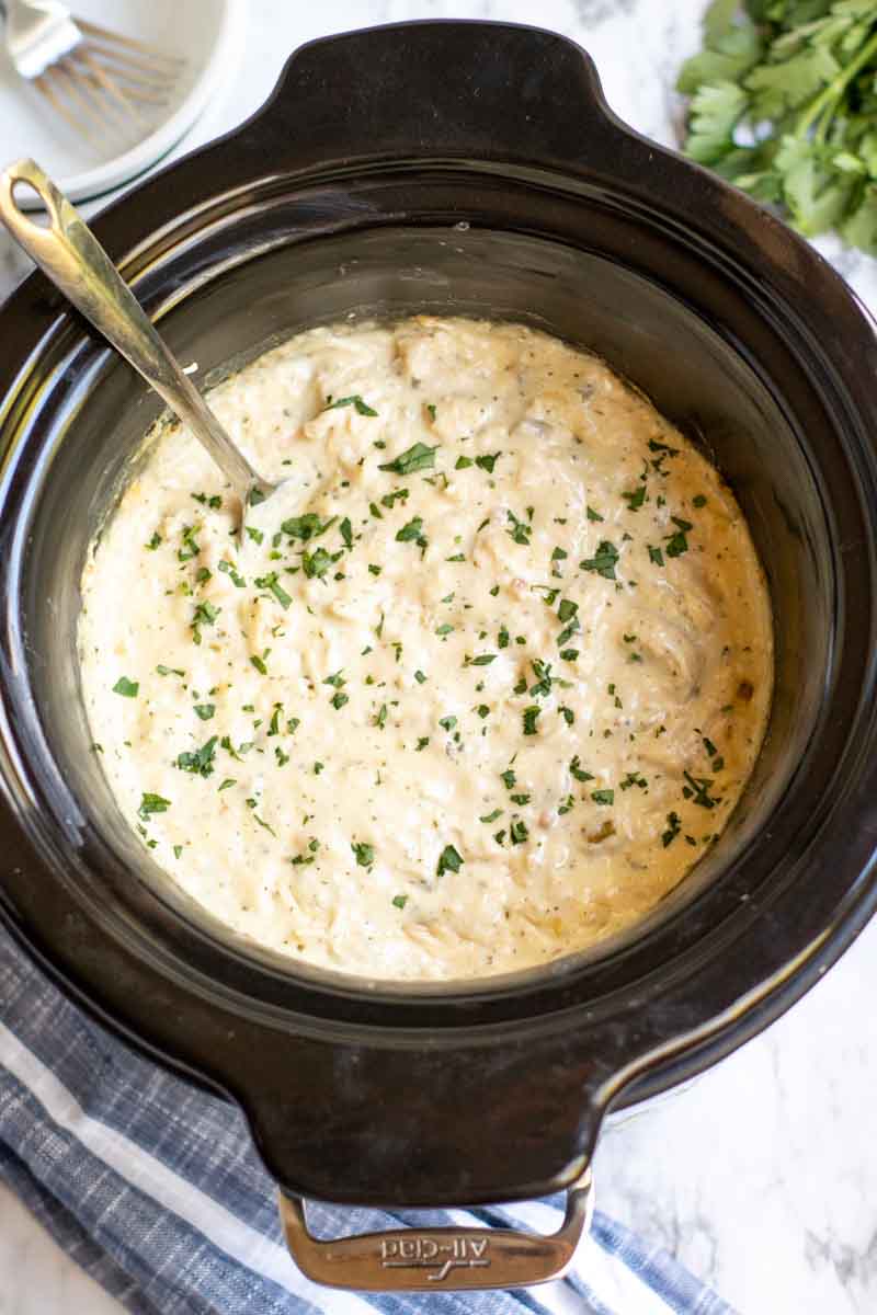 overhead shot of creamy ranch chicken in a slow cooker