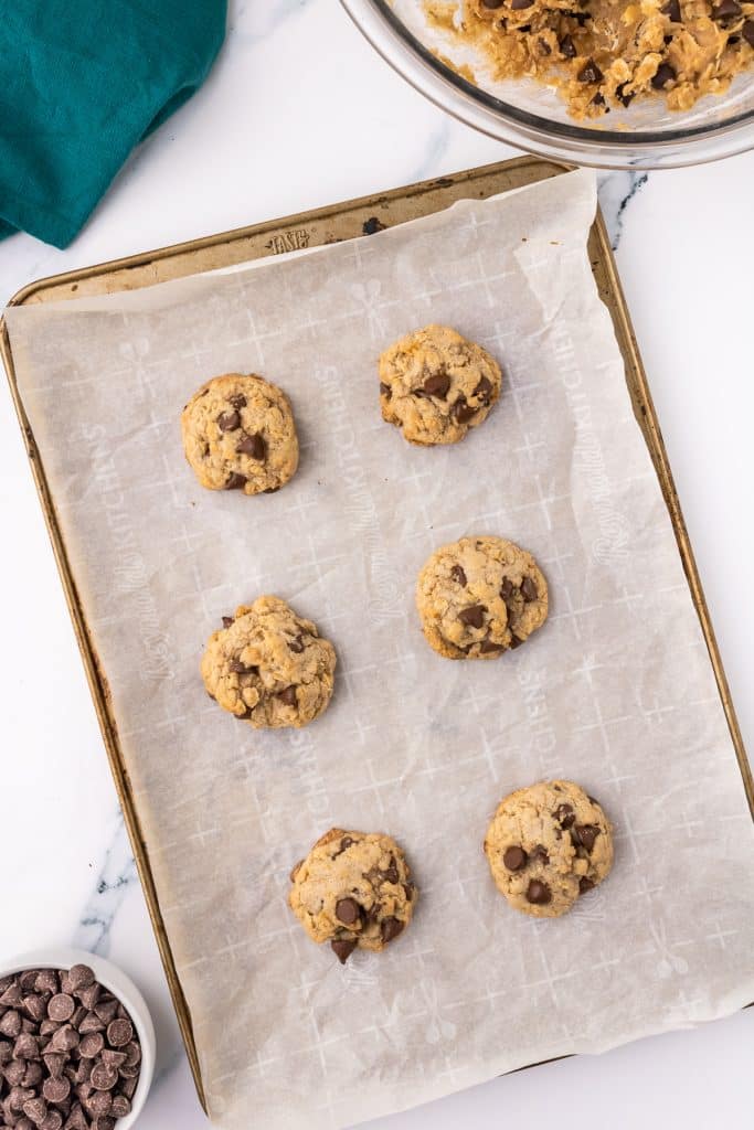 overhead shot of oatmeal chocolate cookies on a baking sheet.