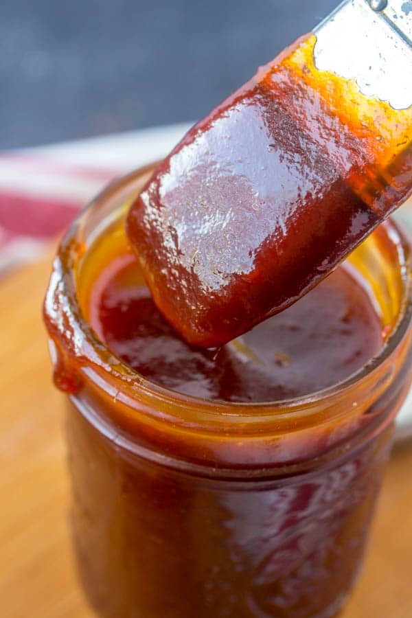 close up of bbq sauce with brush in mason jar