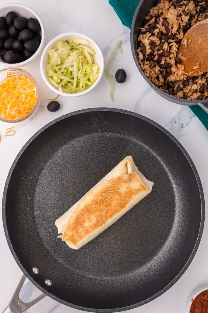 a toasted burrito in a skillet.