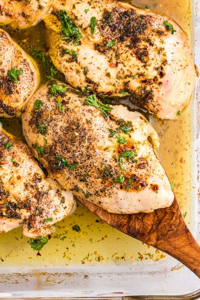 baked chicken breast on a wooden spatula.
