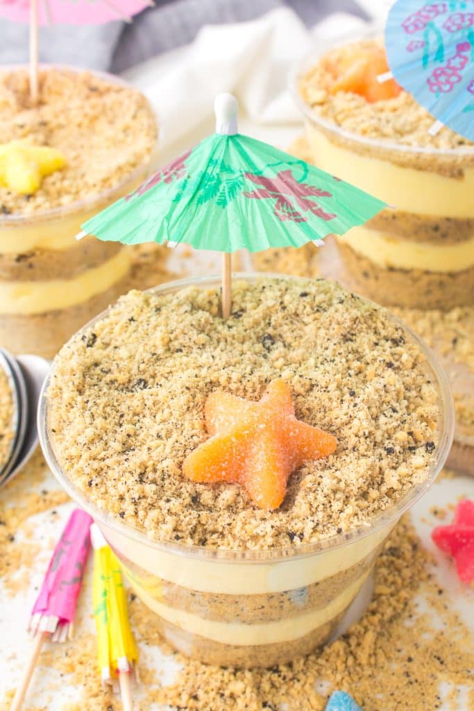 layered sand pudding dessert with a mini umbrella.