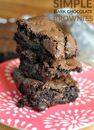 stack of homemade dark chocolate brownies on a red plate