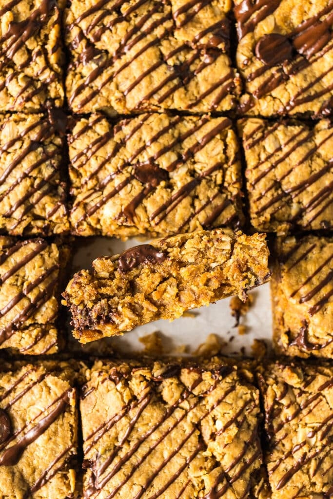sliced oatmeal peanut butter bars with one on its side.