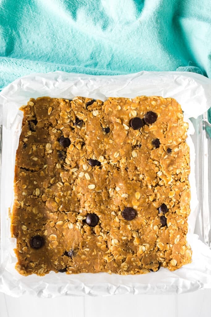 oatmeal peanut butter bars pressed into a pan before baking.