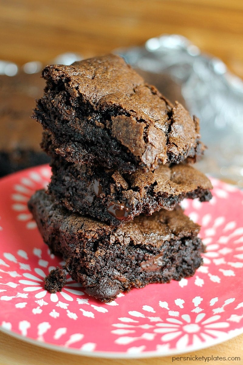 stack of three brownies on a red plate