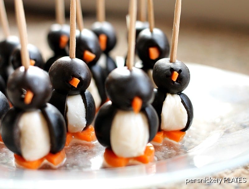 These Olive Penguins are made with black olives, mozzarella balls, and carrots. They are an adorable and fun appetizer, perfect for game day or small gatherings. These delicious poppers are almost too cute to eat!
