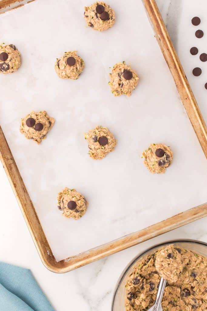 overhead shot of cookie dough scooped onto a baking sheet.