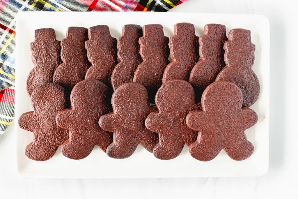 plate of chocolate cookies in gingerbread & snowmen shapes