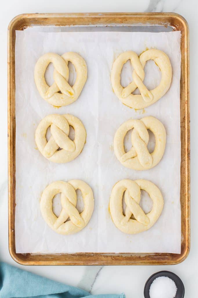 unbaked pretzel dough on a baking sheet.