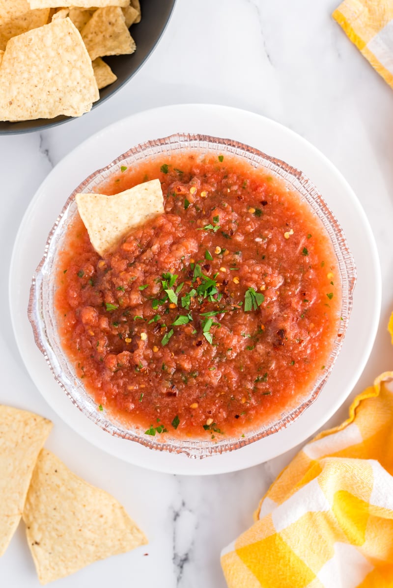overhead shot of fresh salsa in a bowl surrounded by chips