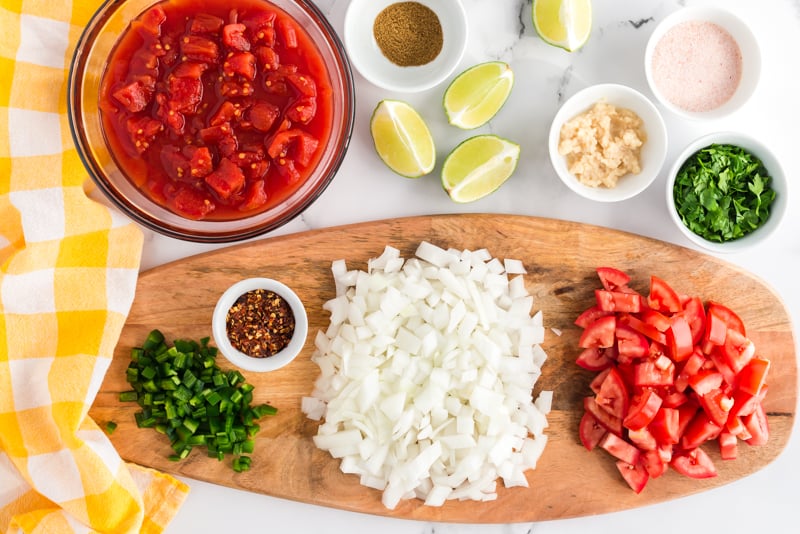 salsa ingredients prepped on a cutting board