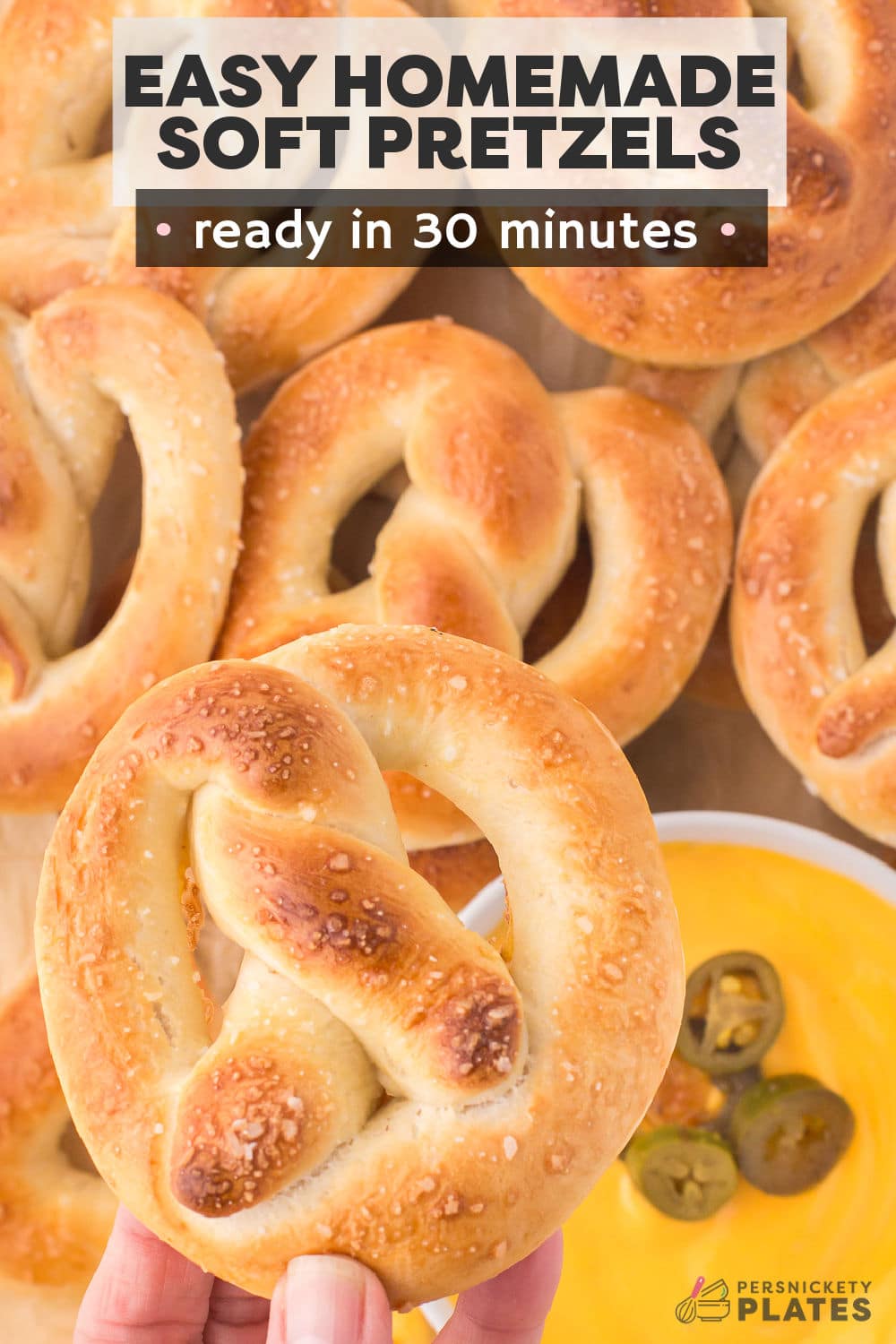 This easy homemade soft pretzel recipe yields a soft chewy texture with a golden brown crust. It's a foolproof recipe that requires no baking soda solution, no resting the dough, and no fancy mixers to get the signature pretzel flavor we all crave! This satisfying snack is made with a simple dough baked with a sprinkle of sea salt. They're even better with a side of your favorite dipping sauce!  | www.persnicketyplates.com