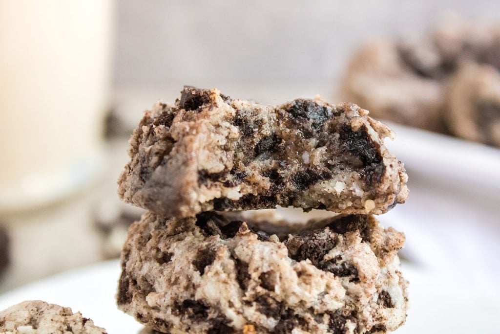 stack of oreo cheesecake cookies with a bite missing from the top cookie.