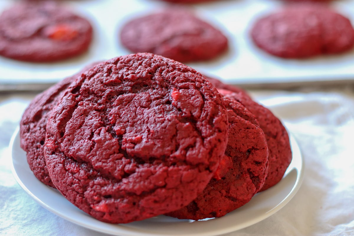 stack of red velvet cream cheese swirl cookies on a white plate