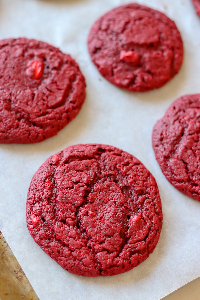 red velvet cream cheese swirl cookies on a baking sheet fresh from oven