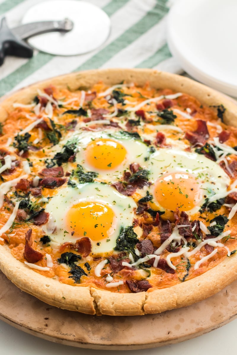 breakfast pizza topped with cooked eggs