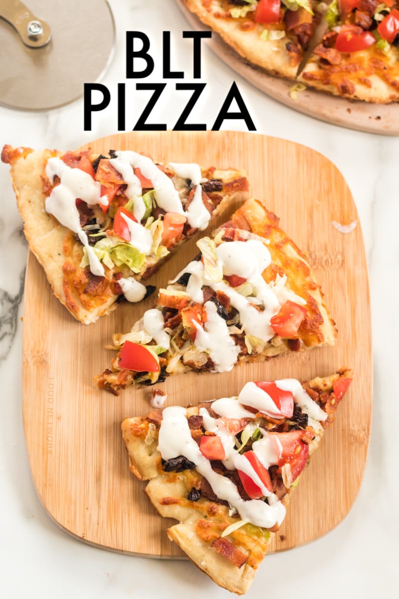 3 slices of blt pizza on wood cutting board drizzled with ranch dressing