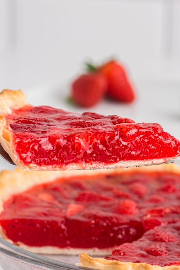 slice of strawberry pie being lifted from a pie.