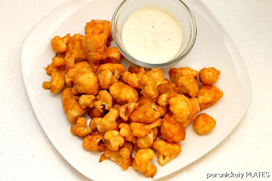 cauliflower buffalo wings on white plate with ranch cup