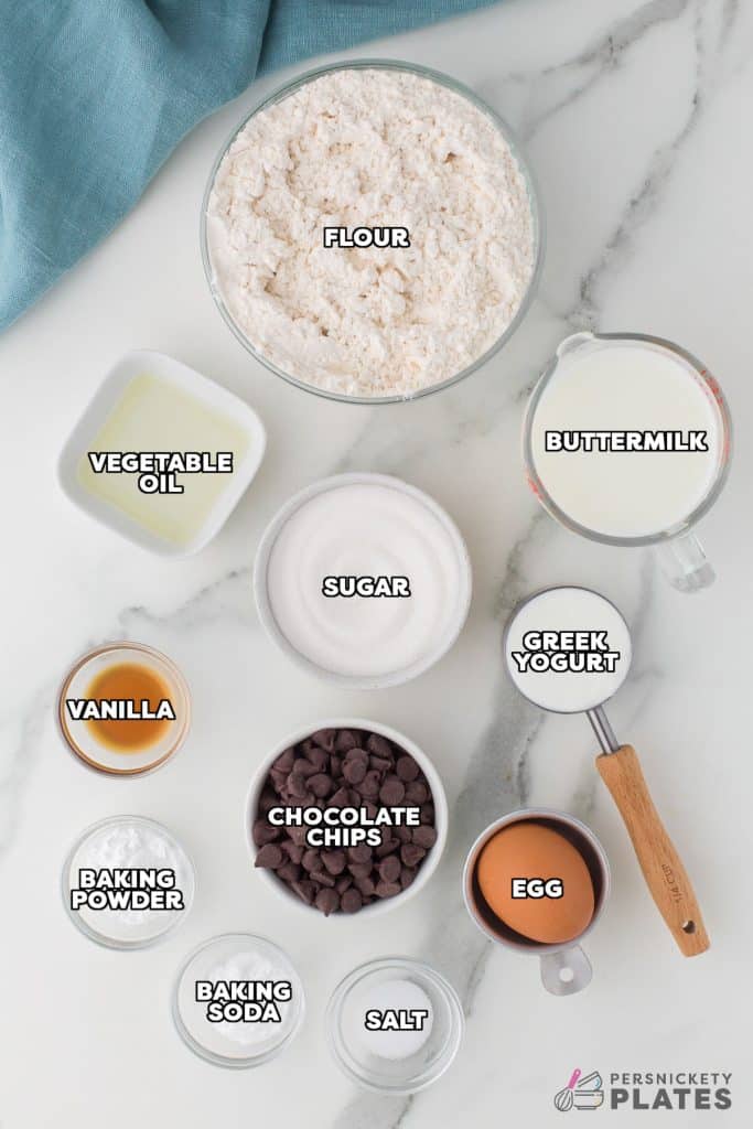 overhead shot of labeled ingredients laid out to make chocolate chip muffins.