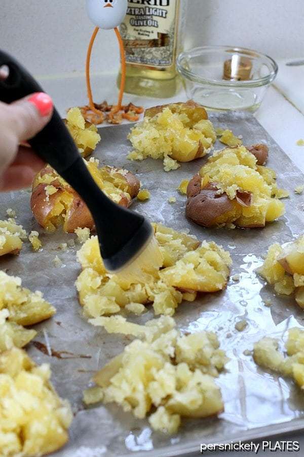 brushing olive oil and crash hot potatoes