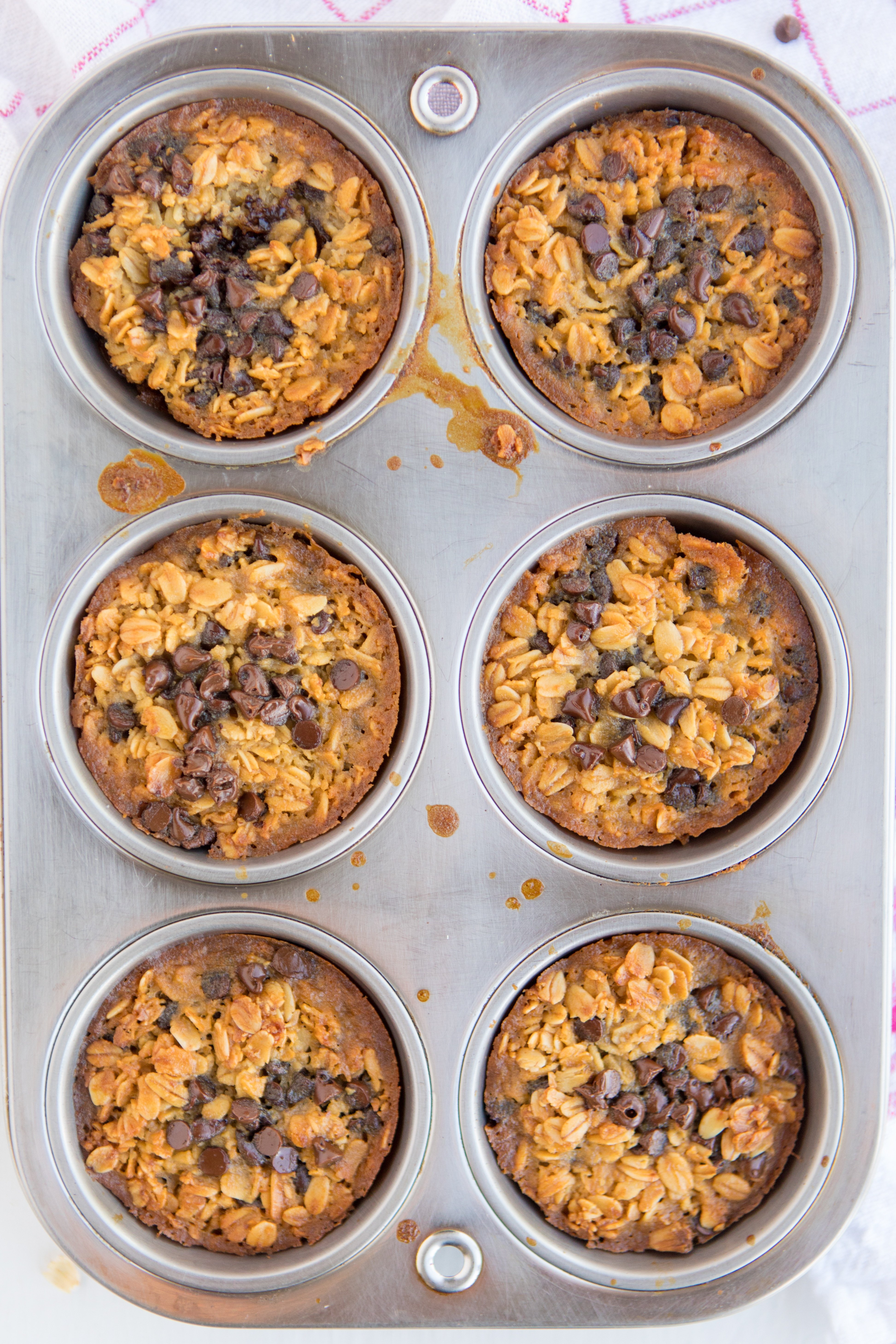 muffin pan of 6 Baked Oatmeal Breakfast Cups sprinkled with mini chocolate chips fresh from the oven