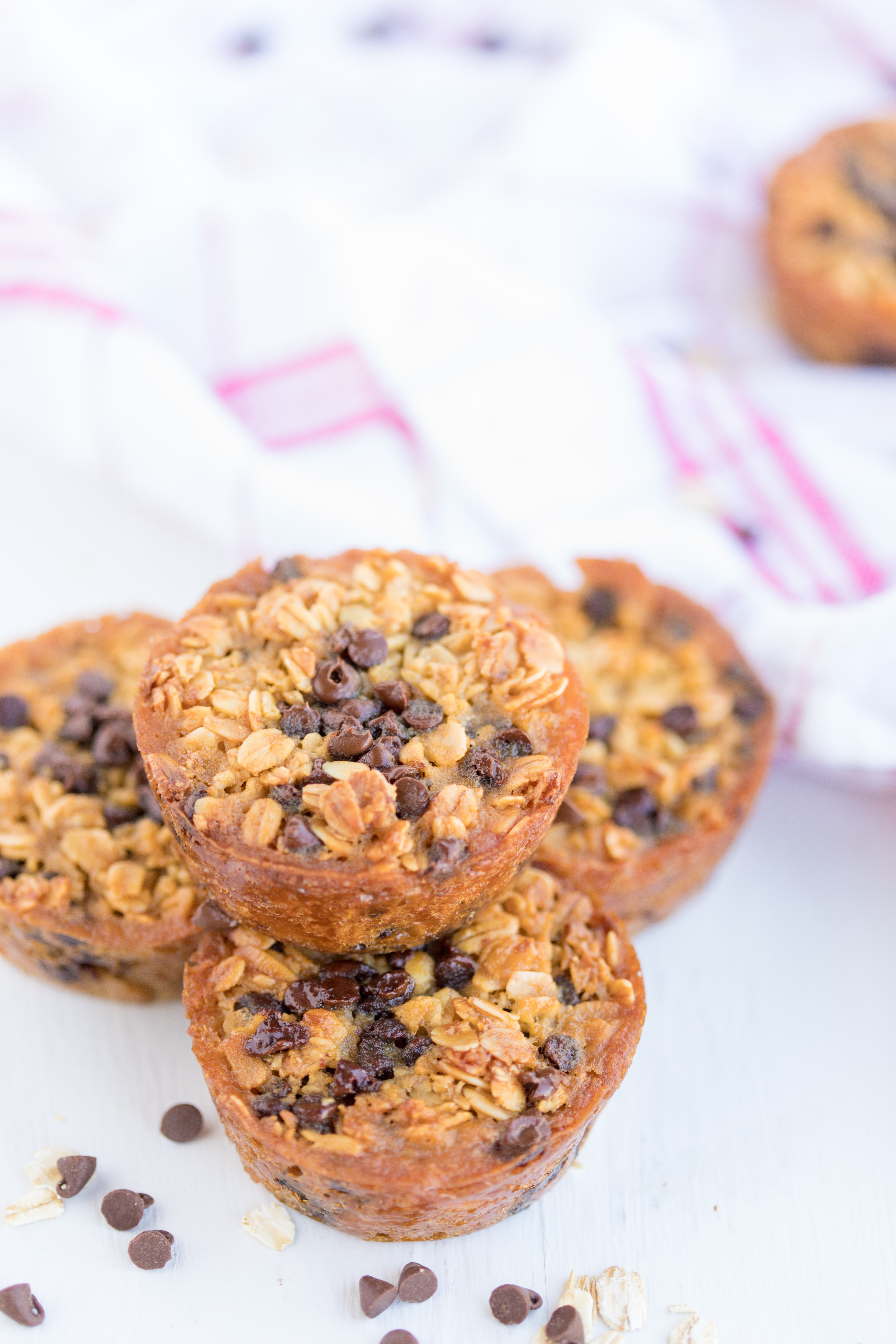 stack of 4 Baked Oatmeal Breakfast Cups surrounded by mini chocolate chips